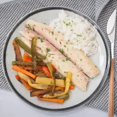 Deliciosa lubina a la sal, servida con arroz blanco y verduras asadas. Un plato saludable y lleno de sabor.