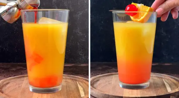 Un cóctel **tequila sunrise** con capas de naranja y rojo, decorado con una rodaja de naranja y una cereza.