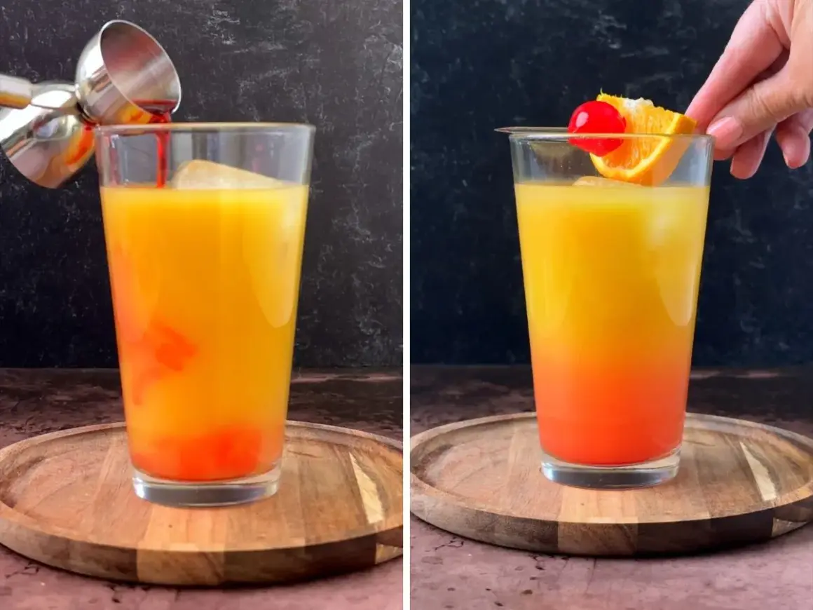 Un cóctel **tequila sunrise** con capas de naranja y rojo, decorado con una rodaja de naranja y una cereza.