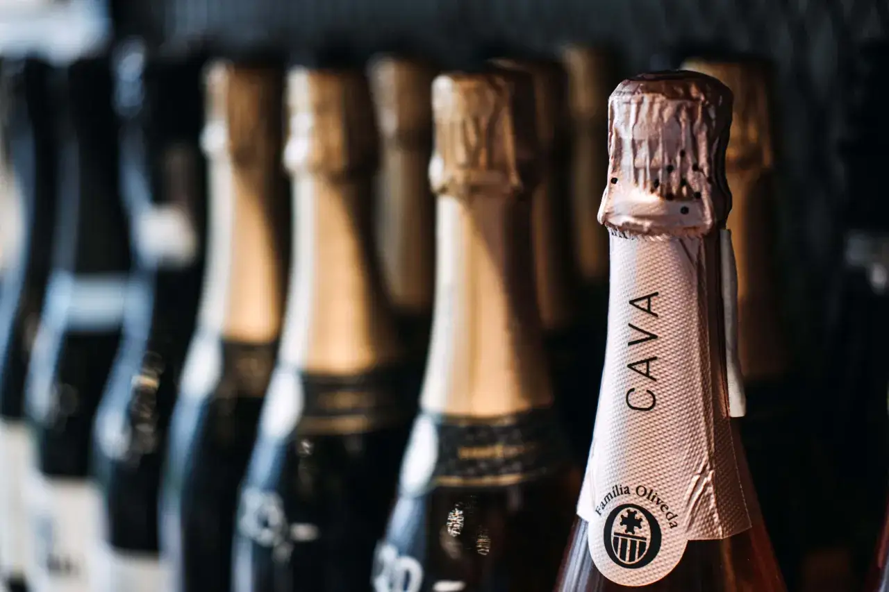 Botellas de cava español en fila. El cava es un vino espumoso español, perfecto para celebrar.